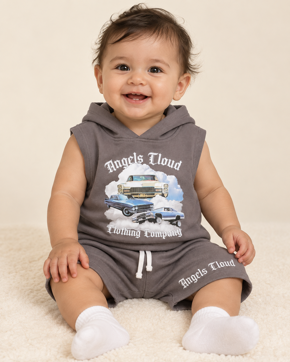 Baby wearing a gray Caddy Dreams sleeveless hooded top and matching shorts.