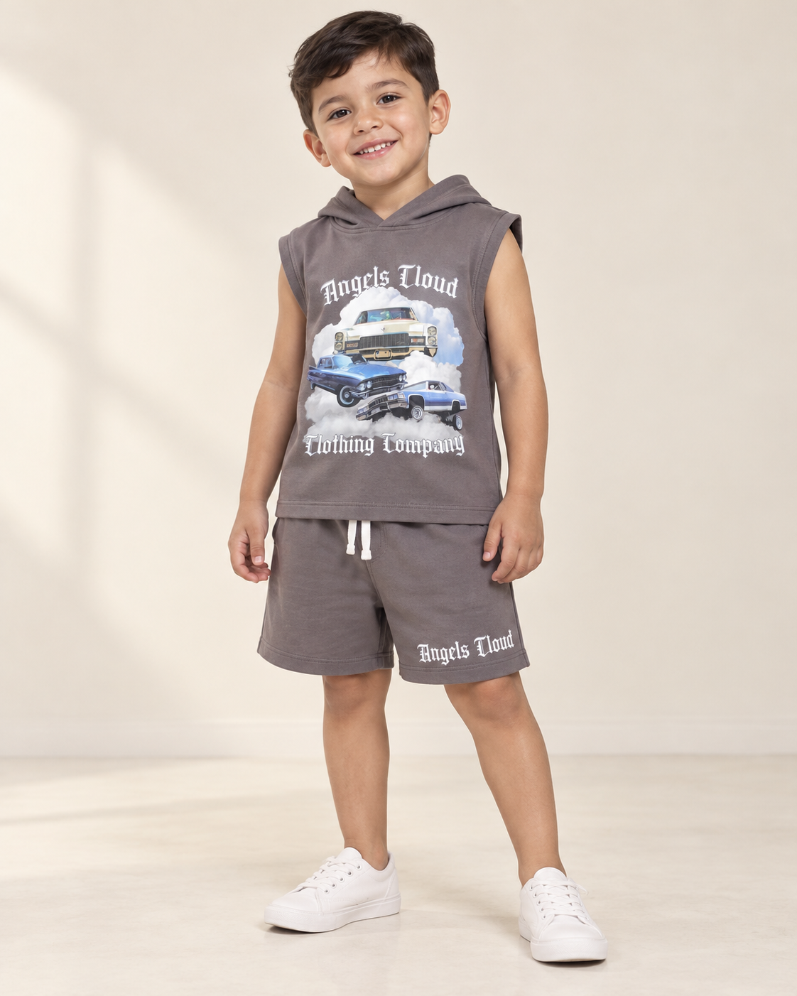 Child wearing a gray Caddy Dreams sleeveless hooded top and matching shorts.