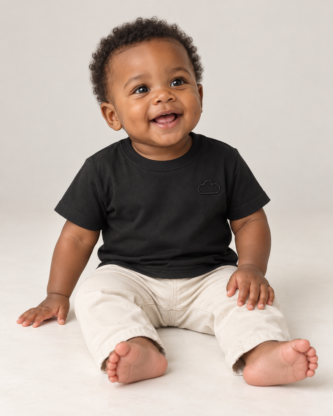 Baby wearing a Midnight Classic Black Tee with a subtle cloud outline.