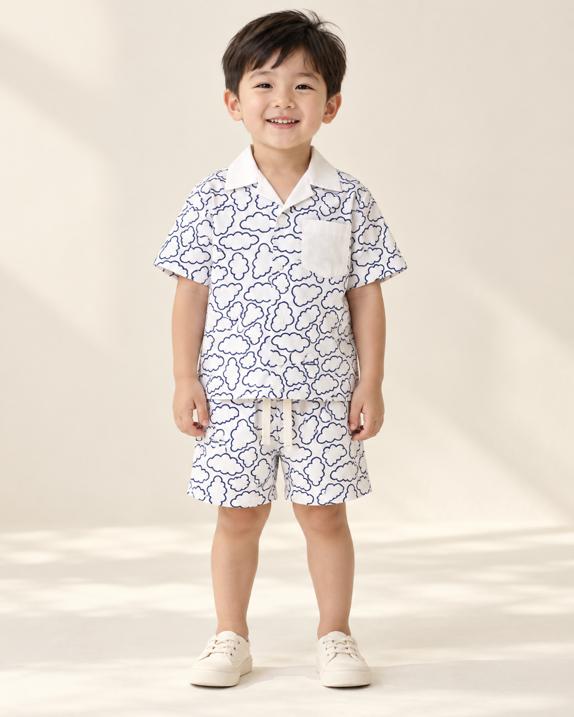 Child wearing a white Relaxed Clouds printed shirt and matching shorts.