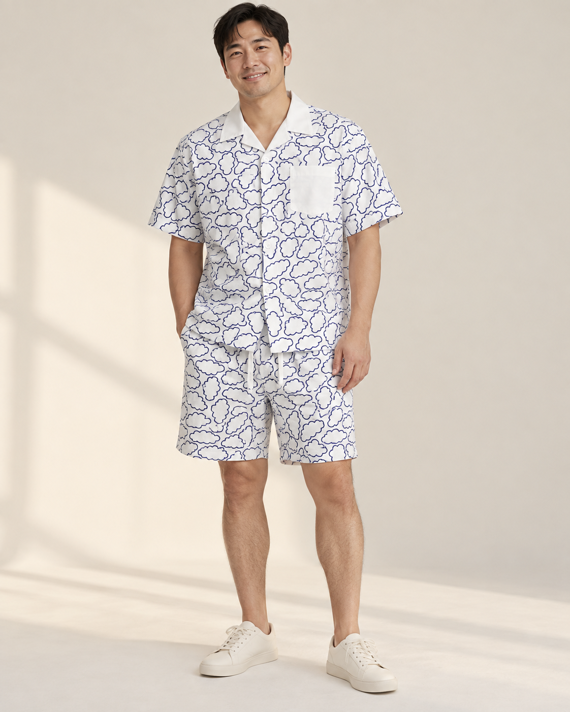 Father wearing a white Relaxed Clouds printed shirt and matching shorts.