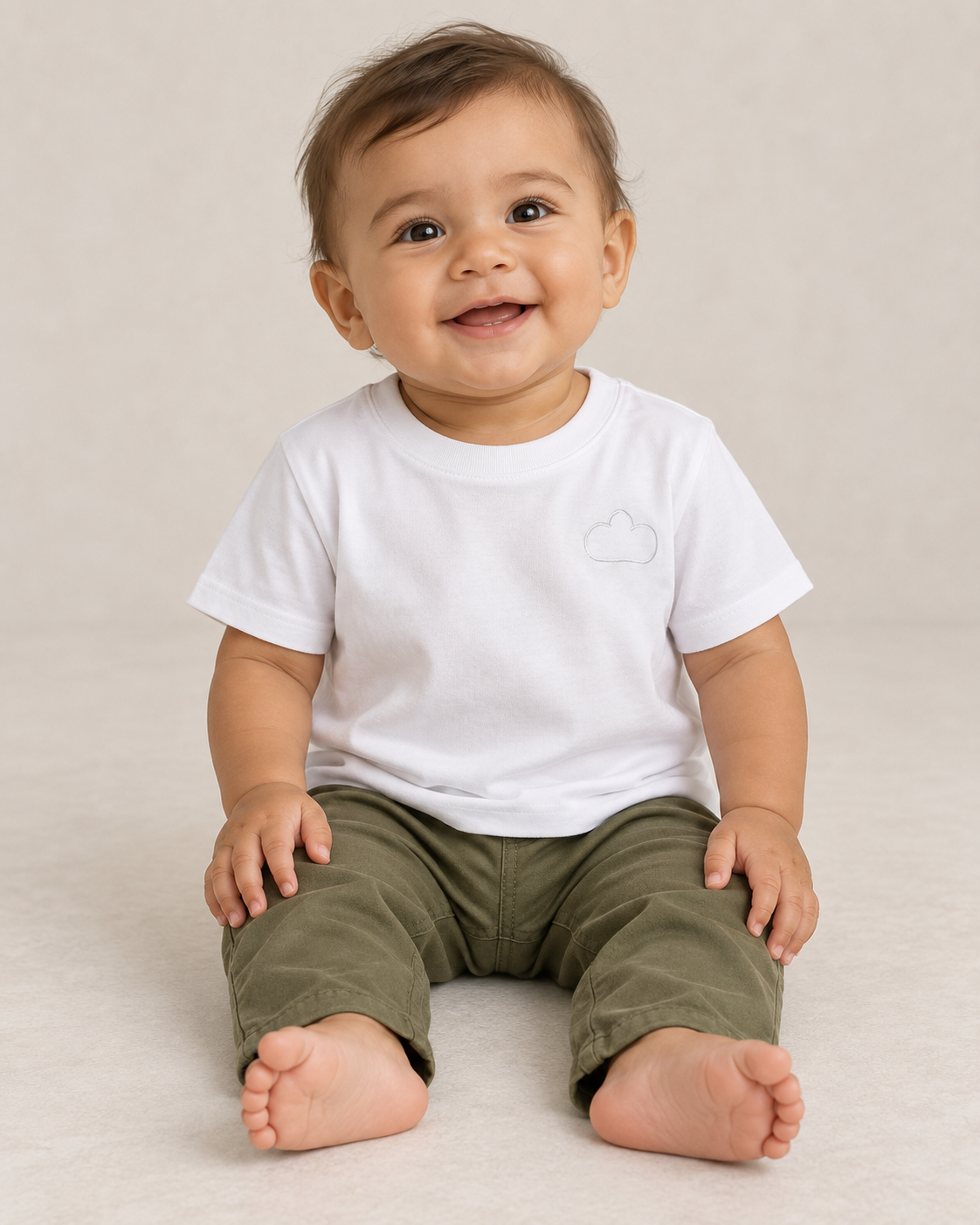 Baby wearing a White Horizon Tee with a tonal cloud outline.